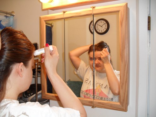 applying cream to hairline